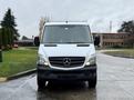 A 2017 Mercedes-Benz Sprinter van facing forward with a white exterior and iconic Mercedes logo on the grille