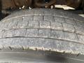 Close-up of a tread-worn tire with visible grooves and a rough surface on a 2016 RAM 5500