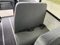 A gray passenger seat in a 2022 Freightliner B2 bus featuring a safety belt