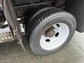 A close-up of a tire on a 2011 Dodge Ram 5500 showing a Continental tire with visible tread patterns and a silver wheel rim