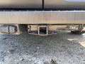 A close-up of the trailer hitch receiver on a 2025 Ford Transit T-350 showing its square opening and electrical connections