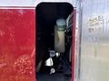 A 1994 Volvo FE 42 with an opened compartment displaying a coolant reservoir and associated components