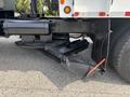 A 2013 International WorkStar truck with a black lift assembly and undercarriage components visible in the foreground