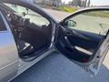 A 2006 Pontiac G6 with an open driver's side door showing the interior including seats and dashboard