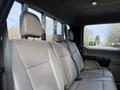 Interior of a 2020 Ford F-550 showing the backseat with three headrests and seat belts on beige upholstery