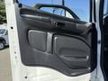 Interior door panel of a 2020 Hino 268 featuring a smooth black surface with a handle and control buttons for window and door functions