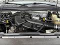 Engine compartment of a 2008 Ford F-350 showing the engine components including the air intake and various hoses and fluid reservoirs
