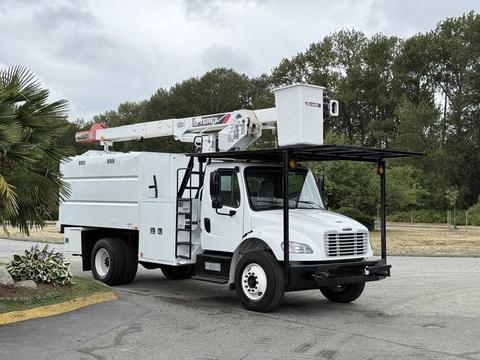 A 2021 Freightliner M2 106 bucket truck with a white body and an elevated boom arm for lifting and accessing overhead work