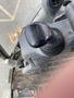 A close-up view of a joystick control from a 2012 John Deere 310SJ backhoe loader
