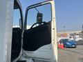 A 2012 Hino 338 truck with an open driver's door showcasing the interior and dashboard controls