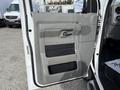 The image shows the interior door panel of a 2013 Ford Econoline featuring a gray design with a handle and speaker grille