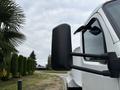 A 2025 Peterbilt 536 truck features a large black side mirror and a sleek white exterior with distinctive design elements