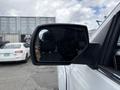 A 2017 Chevrolet Silverado 1500 side mirror is shown reflecting part of the vehicle and surrounding area