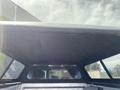 Interior view of a 2014 Ford F-150 truck bed with a cap showing the ceiling and side windows