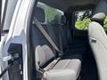 The image shows the rear seating area of a 2019 Ford F-150 with gray fabric seats and seatbelts installed