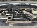 A 2015 Ford F-450 engine featuring various components including hoses wires and engine parts arranged in a compact engine bay
