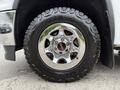 Chrome wheel with a black off-road tire on a 2016 GMC Sierra 1500 showcasing the GMC logo embedded in the center hub