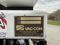 A metal identification plate attached to a vehicle displaying model and serial numbers along with manufacturer information for a Vac-Con truck