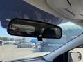 A 2016 Ford Escape's interior rearview mirror showing a reflection of the car's backseat and part of the dashboard