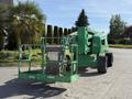 A green 2015 JLG 450AJ articulating boom lift with a work platform raised and large wheels for mobility