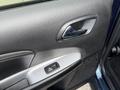 Interior door panel of a 2013 Dodge Journey featuring a silver handle and a window control button