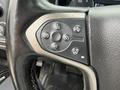 Close-up of the steering wheel controls for a 2017 Chevrolet Silverado 1500 featuring buttons for cruise control and various functions
