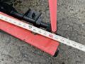 A close-up of a 2012 Dodge Ram 5500 with a measuring tape laid across a red component on the vehicle's undercarriage