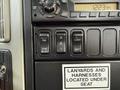 Dashboard control panel of a 2011 International 4300 featuring buttons for engine brake, differential lock, and an alarm clock display
