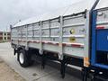 A 2017 Autocar Xpert truck with a metallic trailer featuring a sloped roof and multiple panel sections along the sides