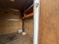 Interior of a 2016 Continental cargo trailer featuring wooden walls shelves and metal racks with visible electrical wiring and a book on the floor