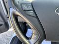 Close-up of the steering wheel of a 2015 Hyundai Sonata featuring audio control buttons for volume and mode