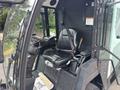 A 2019 Madvac LS175 vehicle interior featuring a black driver's seat with seatbelt controls and various dashboard levers and buttons