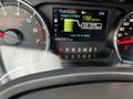 Dashboard of a 2014 Ford F-150 displaying fuel information and performance metrics including fuel economy and distance to empty