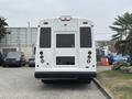 A white 2020 Chevrolet Express van viewed from the rear featuring large windows and a wheelchair access door