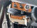 A close-up of a 2008 Peterbilt 340's gear shift lever featuring a light control icon with directional arrows