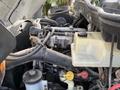 Close-up view of the engine compartment of a 2010 International 4300 showing various components including hoses and a fluid reservoir