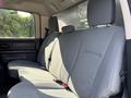 The image shows the back seat area of a 2013 RAM 5500 with gray fabric upholstery and seat belts visible on the passenger side