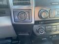 The image shows the dashboard controls of a 2017 Ford F-150 including a four-wheel drive selector and audio controls
