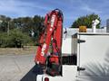 A red hydraulic crane mounted on a white truck with a yellow light on top and a storage compartment on the side
