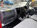 Interior of a 2001 Toyota Dyna showing dashboard controls gear stick and seating with patterned upholstery