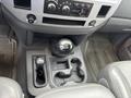 Interior view of a 2006 Dodge Ram 2500 showing the gear shifter and center console with cup holders and various controls for climate and audio settings