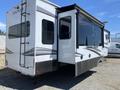 A 2021 Grand Design Recreational ST3478MBS showing its exterior features with multiple slide-outs and large windows