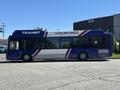 A blue and white 2018 Grande West Vicinity bus labeled as a clean air vehicle with the word transit on the side