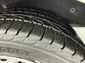 Close-up of a tire tread from a 2017 Ford Transit Connect showing detailed grooves and patterns on the rubber surface