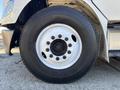 Close-up of a 2005 Freightliner M2 106 tire showing the rim and tread pattern with visible brand markings on the tire