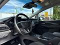 Interior view of a 2023 Chevrolet Bolt EV showcasing the steering wheel dashboard and central console with controls and displays