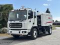 A 2012 Autocar Xpert street sweeper with a white body and a large cleaning apparatus attached to the side