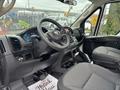 Interior view of a 2023 RAM Promaster 3500 showing the steering wheel dashboard and front seats with a fabric design