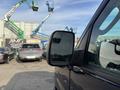 A 2013 Ford E-350 Super Duty van with a side mirror visible in the foreground