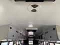 Interior view of a 2009 International 3000 CE school bus showcasing the ceiling with overhead storage compartments and an air vent system